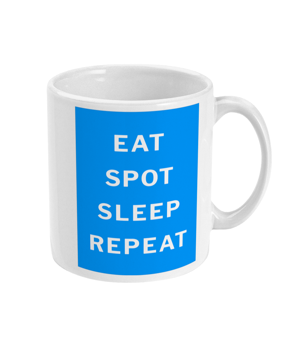 Close view of the mug's Eat, Spot, Sleep, Repeat lettering on the blue background, with handle visible