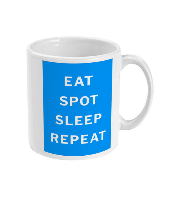 Close view of the mug's Eat, Spot, Sleep, Repeat lettering on the blue background, with handle visible